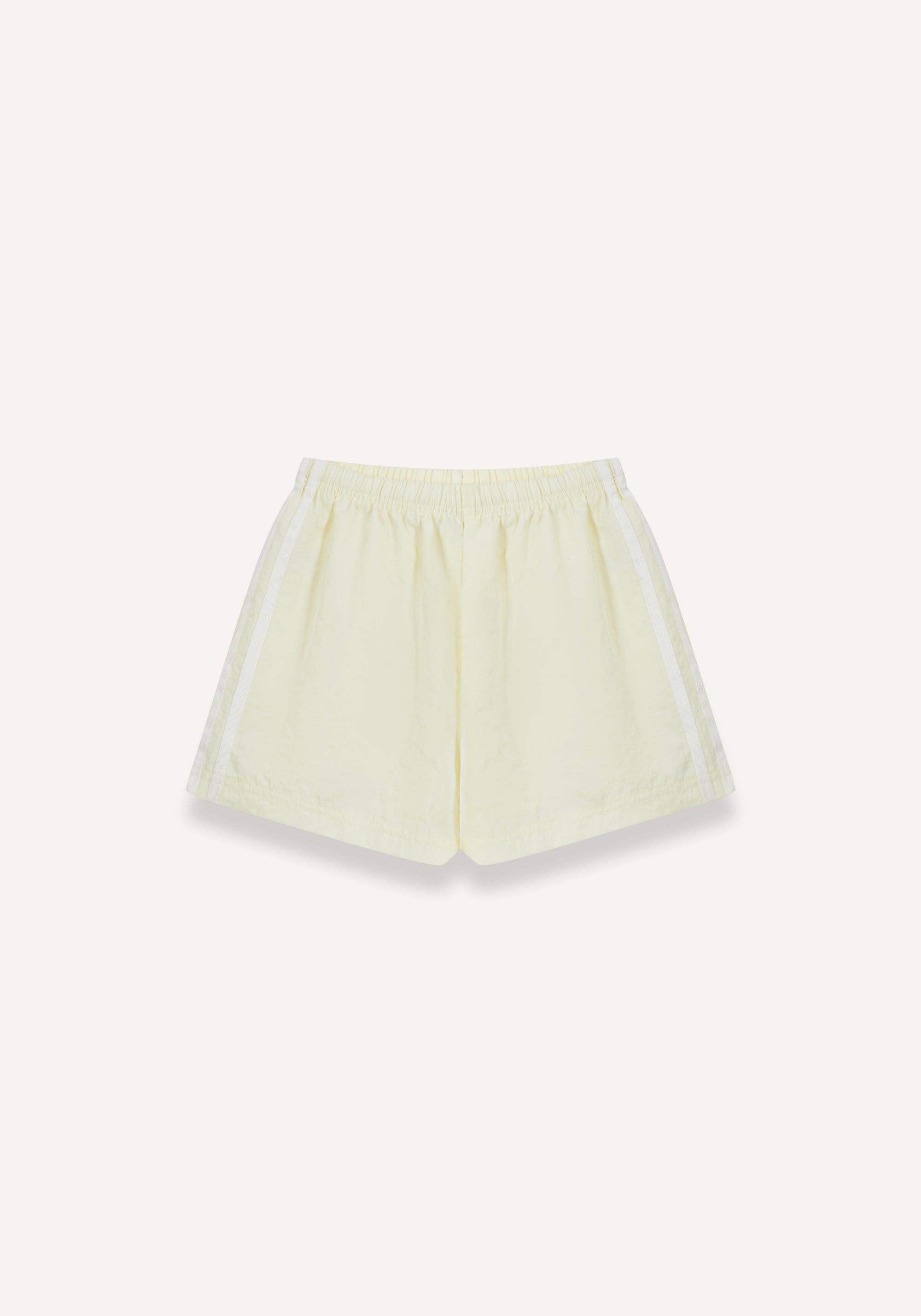 A pair of light yellow athletic shorts with white side stripes, displayed flat against a solid off-white background.