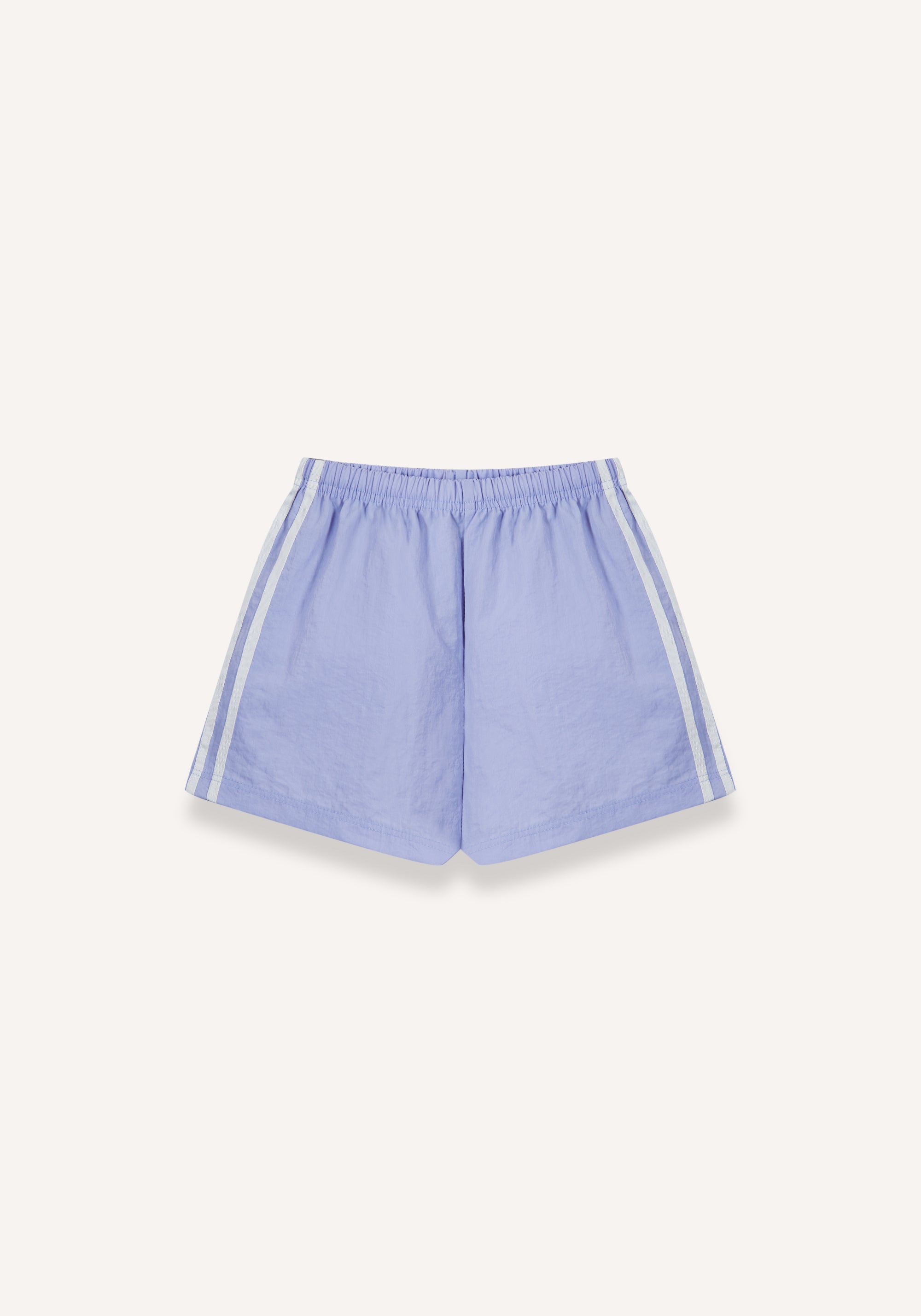 Lilac athletic shorts with white side stripes, displayed flat against a light cream background.
